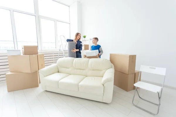 Mother and son are happy about moving to a new house. 