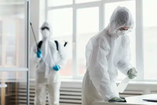 People in protective gear with equipment, disinfecting concept