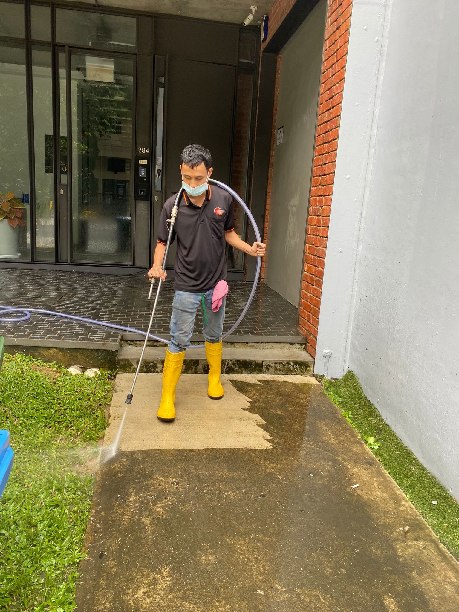 cleaning the patio using pressure washer