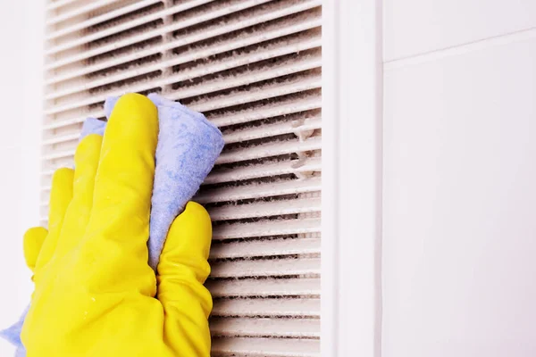 A layer of dust on the ventilation grill in the bathroom, cleaning ventilation.