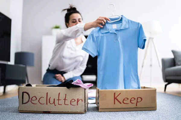 Woman decluttering clothes, sorting and cleaning up.