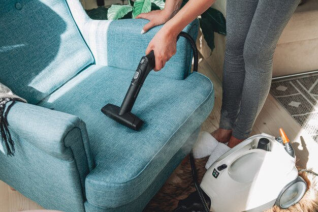 Cleaning a sofa with a steam cleaner