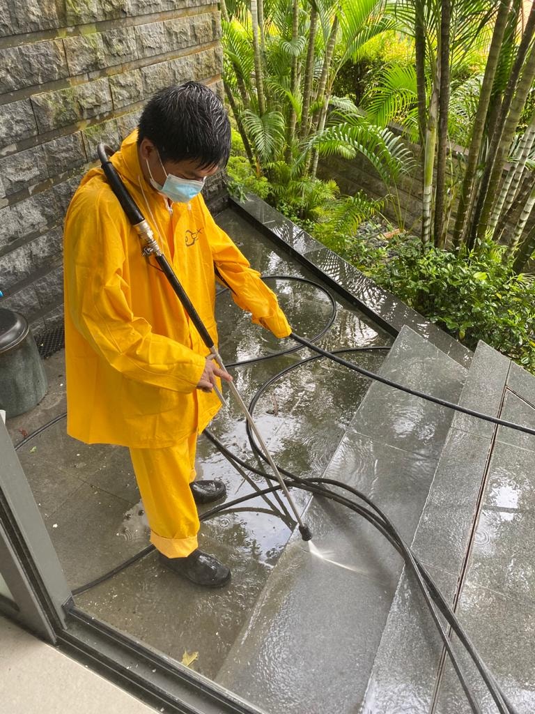 man cleaning the stairs using pressure washer