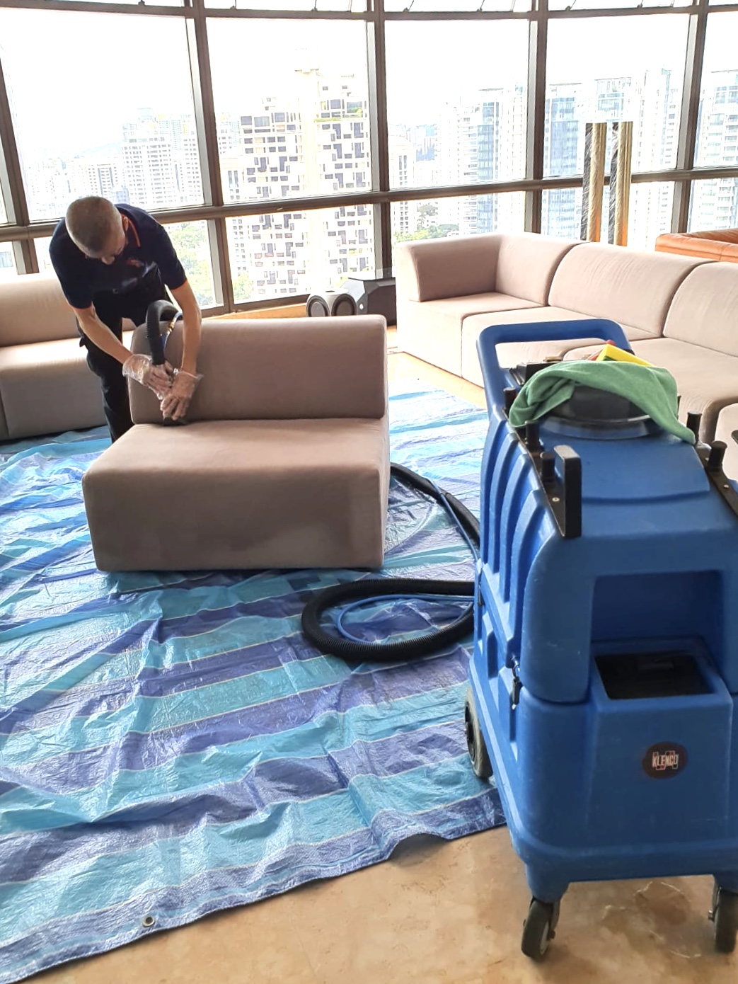 man cleaning sofa