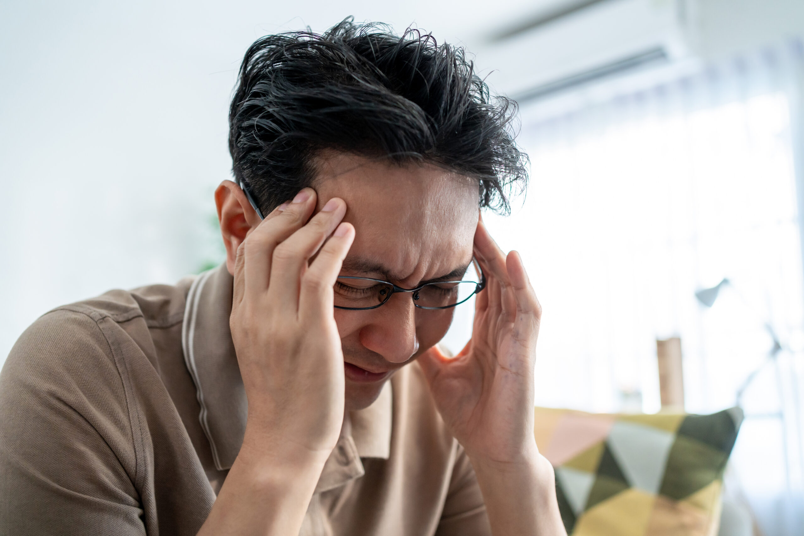 man with headache massaging temples inside home 2026 03 25 03 55 08 utc scaled