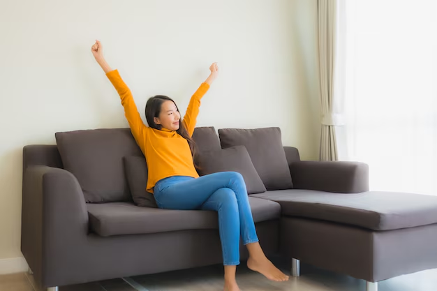 Portrait of Asian woman with a happy, relaxed smile on the sofa