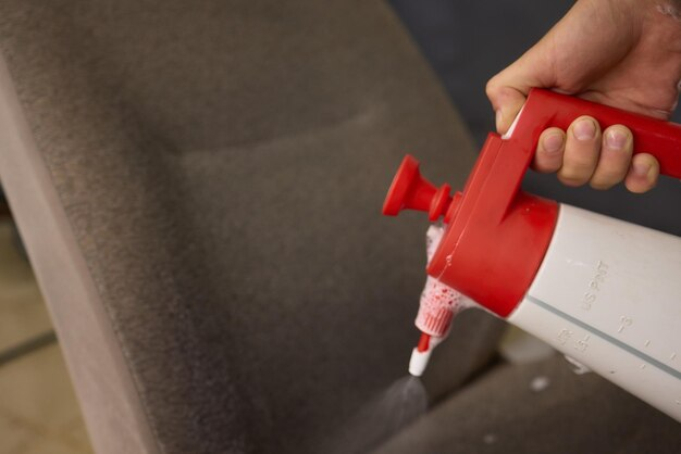 Upholstery cleaning using a spray applicator, close-up