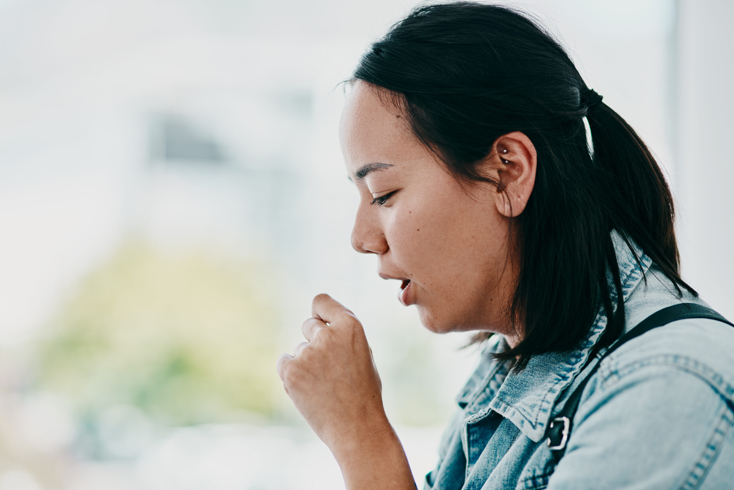 shot of a young woman coughing while waiting in a 2026 03 25 02 48 15 utc scaled