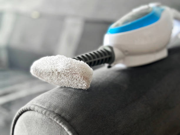 Macro shot of steam cleaner on a sofa arm.