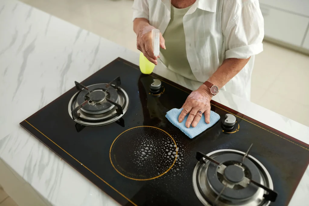 woman cleaning greasy stove 2023 12 29 19 44 29 utc 1